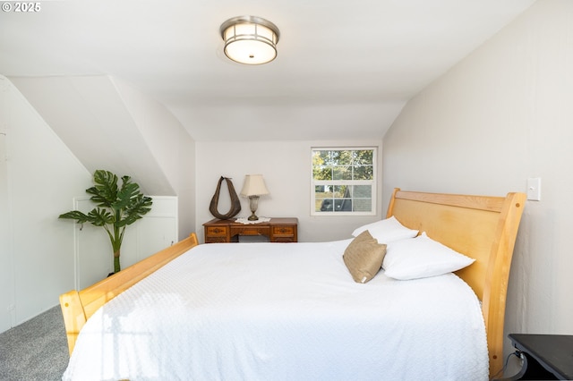 bedroom with lofted ceiling and carpet floors