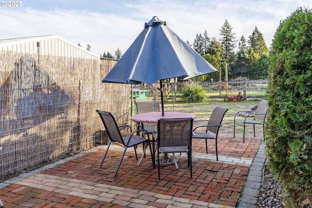 view of patio / terrace featuring outdoor dining area and a fenced backyard