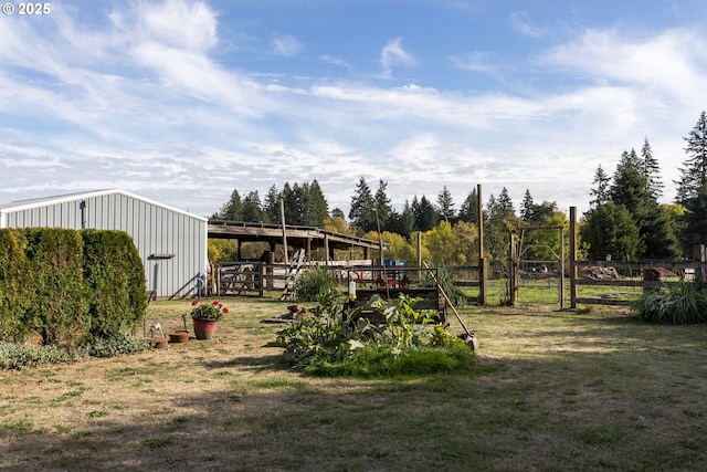 view of yard with an outbuilding and fence