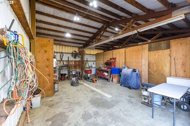 garage featuring a workshop area and metal wall