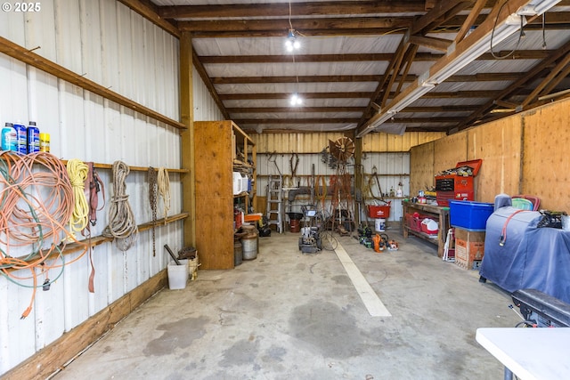 garage featuring a workshop area and metal wall