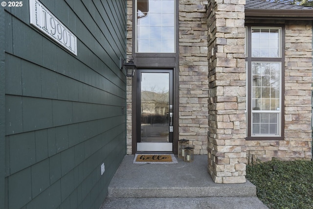 doorway to property with stone siding