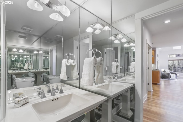 bathroom with visible vents, a sink, and wood finished floors