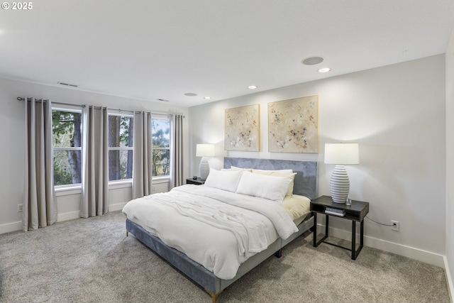 carpeted bedroom featuring recessed lighting, visible vents, and baseboards