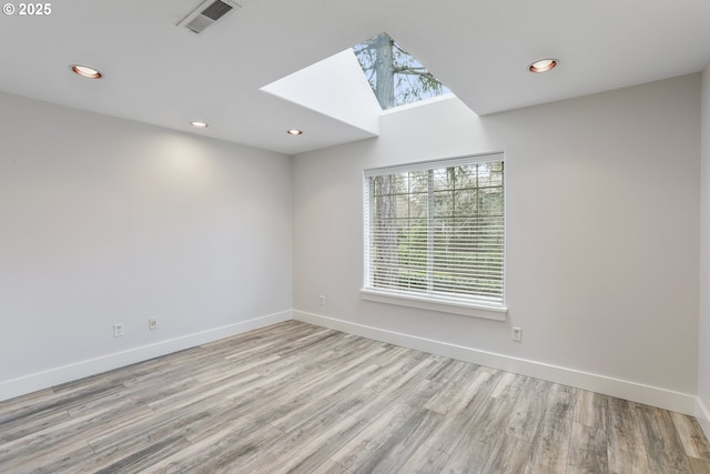 spare room featuring baseboards, visible vents, wood finished floors, and recessed lighting