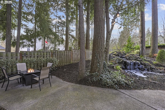 view of patio featuring a fire pit and fence