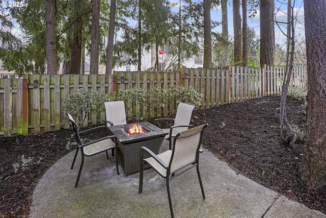 view of patio featuring an outdoor fire pit and a fenced backyard