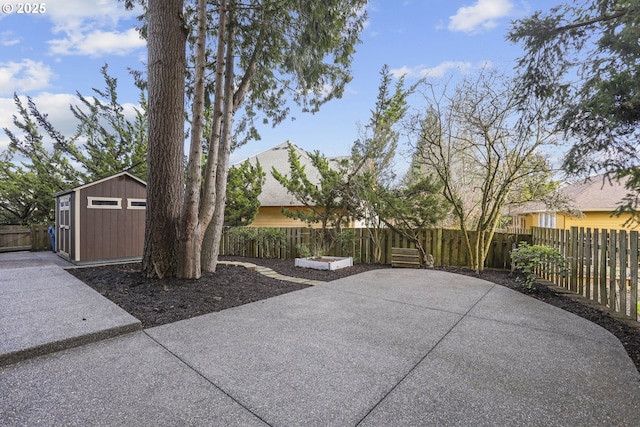 view of patio / terrace featuring fence private yard, a shed, and an outbuilding