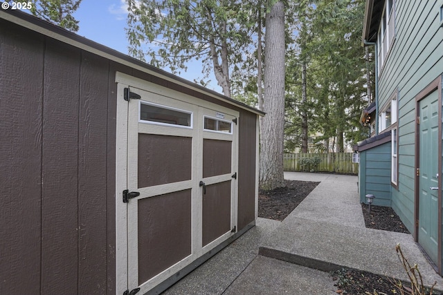 view of shed with fence