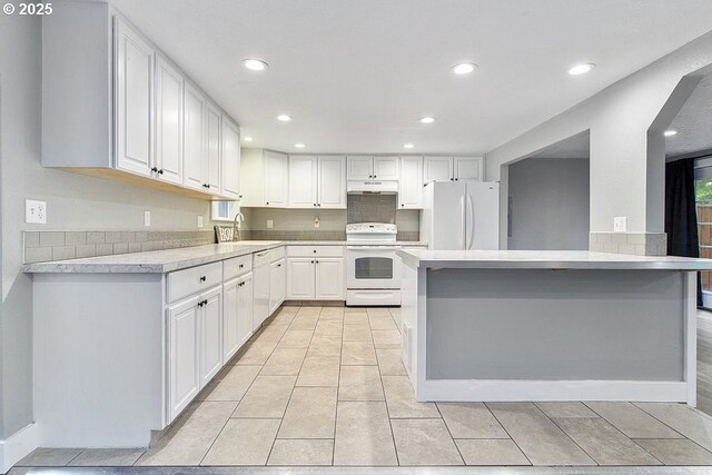 13616 SE Rhine St, Portland, OR 97236 - kitchen featuring white appliances, a sink, light countertops, recessed lighting, and white cabinets