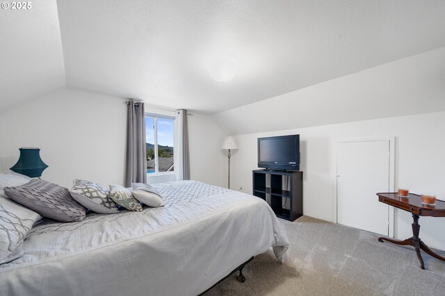 bedroom featuring light carpet and lofted ceiling