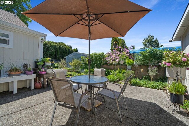 view of patio with fence and outdoor dining area