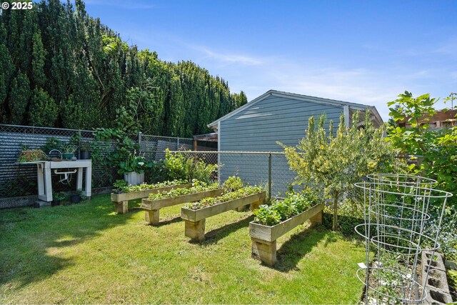 view of yard with a garden and fence