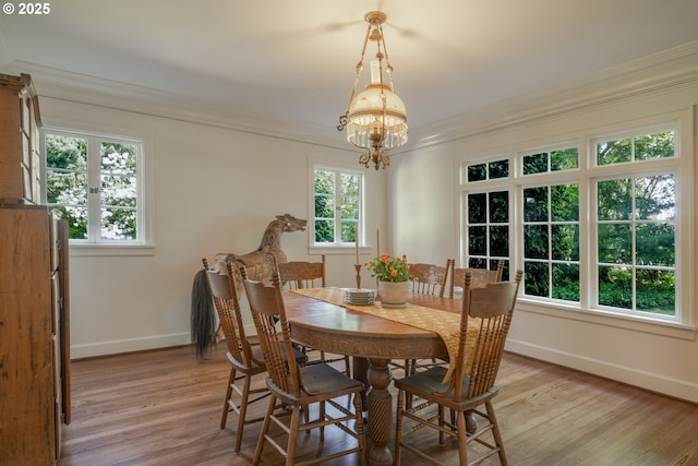 92216 Whiskey Rd, Warrenton, OR 97146 - dining area featuring ornamental molding, baseboards, a chandelier, and light wood-style floors