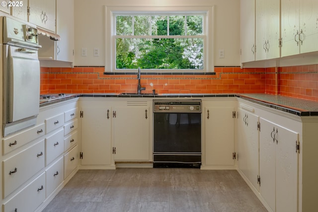 92216 Whiskey Rd, Warrenton, OR 97146 - kitchen featuring black dishwasher, oven, backsplash, a sink, and stainless steel gas cooktop