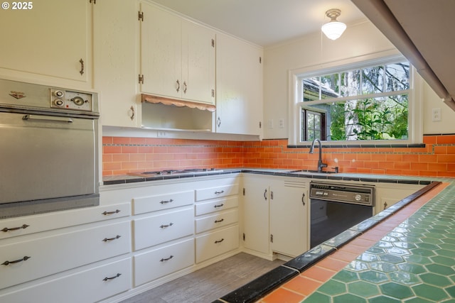 92216 Whiskey Rd, Warrenton, OR 97146 - kitchen with dishwasher, wall oven, gas cooktop, tasteful backsplash, and tile countertops