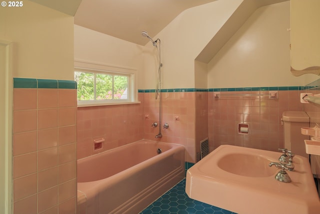 92216 Whiskey Rd, Warrenton, OR 97146 - bathroom featuring tile walls, tile patterned floors, shower / bath combination, and wainscoting