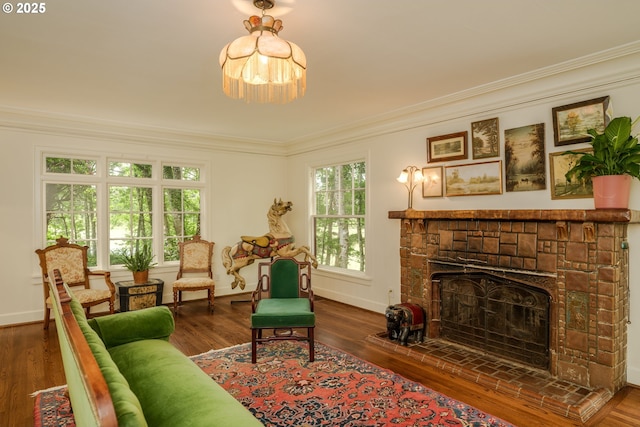 92216 Whiskey Rd, Warrenton, OR 97146 - living area with a fireplace with raised hearth, crown molding, baseboards, wood finished floors, and a chandelier