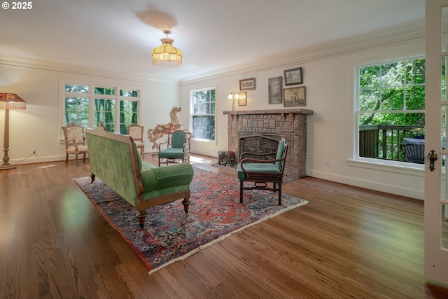92216 Whiskey Rd, Warrenton, OR 97146 - living room with crown molding, a fireplace, baseboards, and wood finished floors