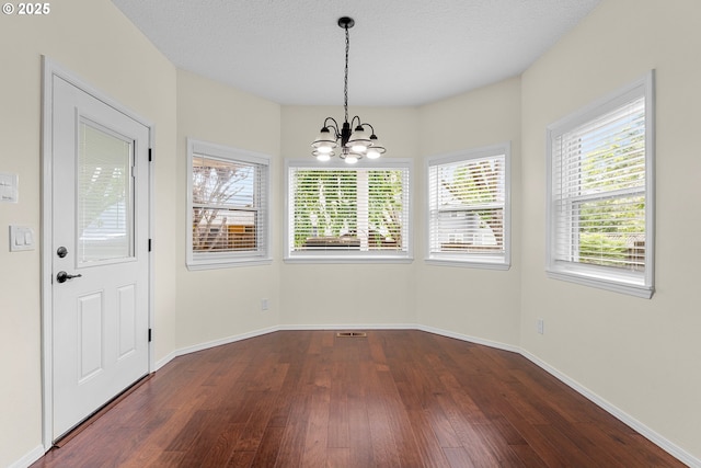 11769 SW 129th Pl, Tigard, OR 97223 - unfurnished dining area featuring dark wood finished floors, a chandelier, and baseboards