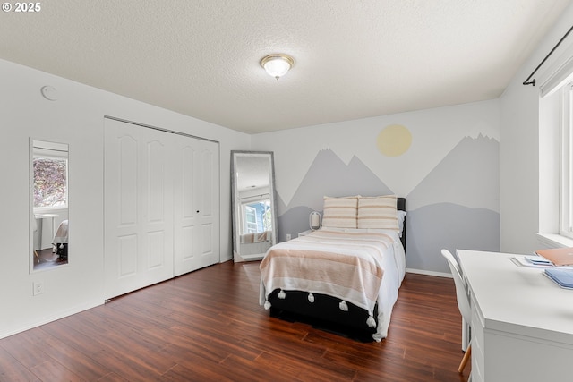 11769 SW 129th Pl, Tigard, OR 97223 - bedroom with dark wood finished floors, a closet, a textured ceiling, and baseboards