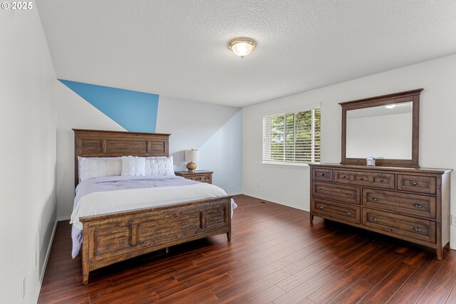 11769 SW 129th Pl, Tigard, OR 97223 - bedroom with dark wood-style flooring, baseboards, a textured ceiling, and vaulted ceiling