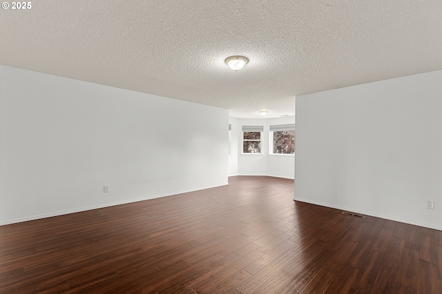 11769 SW 129th Pl, Tigard, OR 97223 - spare room with dark wood-style flooring, a textured ceiling, and baseboards