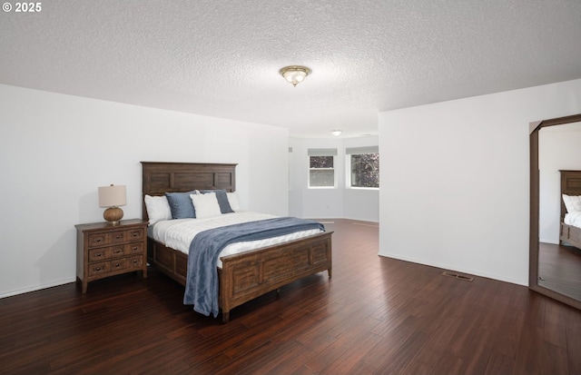 11769 SW 129th Pl, Tigard, OR 97223 - bedroom featuring dark wood-type flooring, a textured ceiling, and baseboards