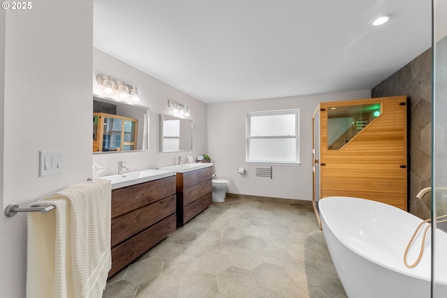 11769 SW 129th Pl, Tigard, OR 97223 - full bathroom with two vanities, walk in shower, a freestanding tub, and recessed lighting