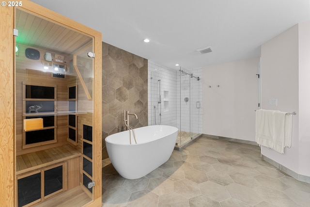 11769 SW 129th Pl, Tigard, OR 97223 - full bathroom featuring a stall shower, a soaking tub, recessed lighting, tile walls, and baseboards