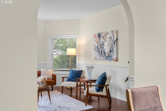 11769 SW 129th Pl, Tigard, OR 97223 - sitting room featuring wood finished floors, wainscoting, and arched walkways