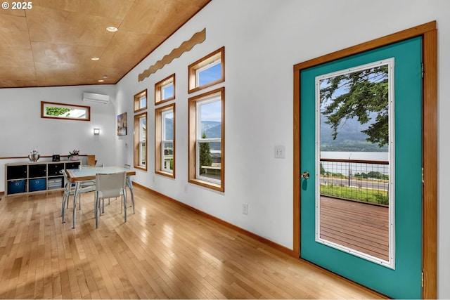 154 NE Tari Ln, Stevenson, WA 98648 - dining room featuring a wall mounted air conditioner, plenty of natural light, light wood-type flooring, lofted ceiling, and a water view