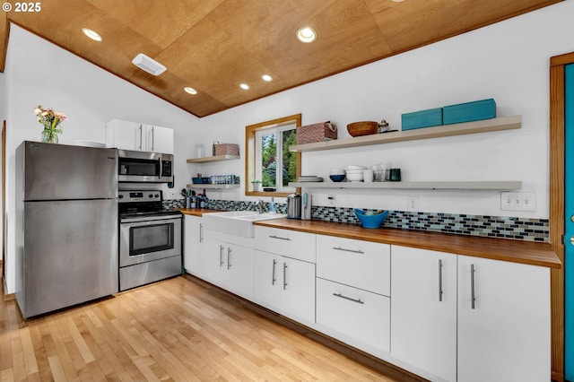 154 NE Tari Ln, Stevenson, WA 98648 - kitchen with stainless steel appliances, open shelves, butcher block countertops, a sink, and lofted ceiling