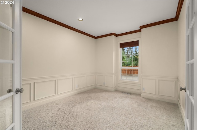 empty room featuring carpet and ornamental molding