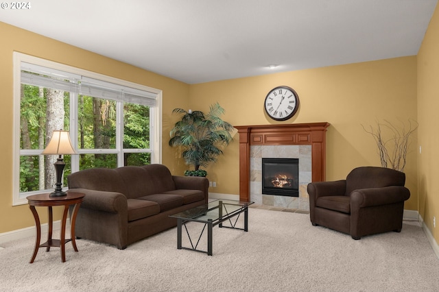 carpeted living room with a tile fireplace