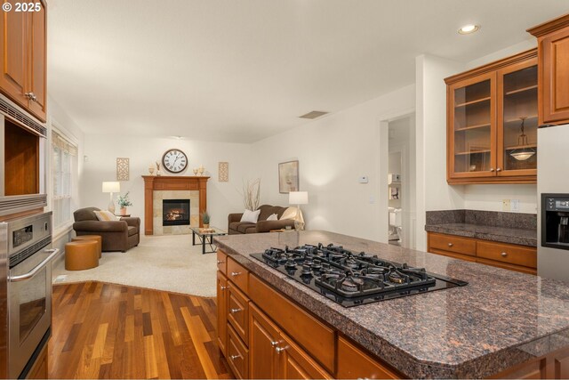 kitchen with pendant lighting, light wood-type flooring, sink, and appliances with stainless steel finishes