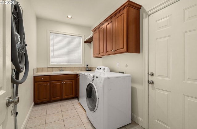 washroom featuring washer and clothes dryer, light tile patterned floors, cabinets, and sink