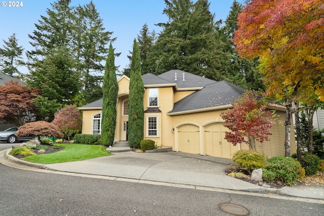 view of front of home featuring a garage and a front lawn