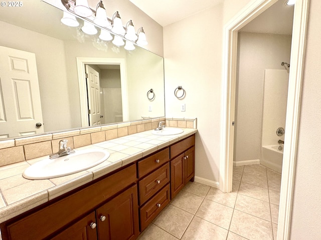 bathroom featuring backsplash, shower / tub combination, tile patterned floors, and vanity