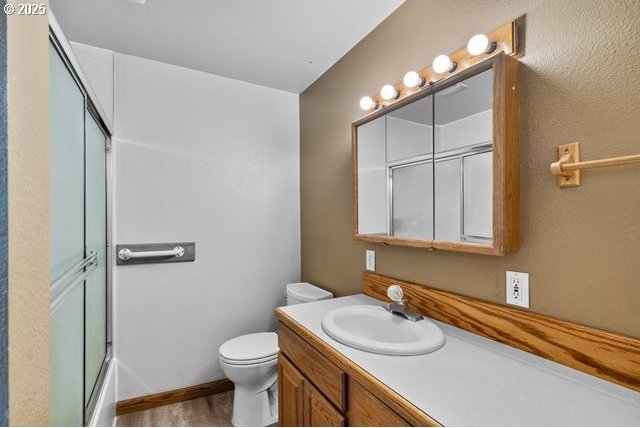 880 Heppner Spray Hwy, Heppner, OR 97836 - full bath featuring toilet, vanity, and wood finished floors