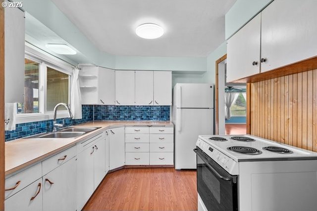 880 Heppner Spray Hwy, Heppner, OR 97836 - kitchen with white appliances, a sink, light wood finished floors, and backsplash