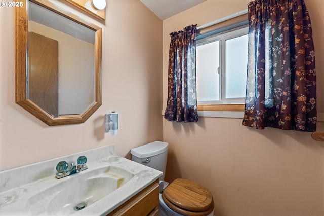 half bathroom with toilet and vanity