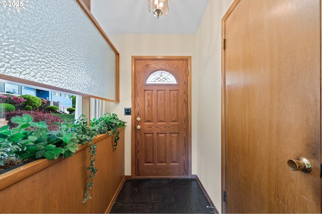doorway to outside featuring baseboards and healthy amount of natural light