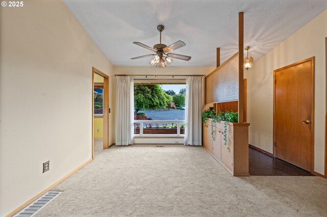 empty room featuring carpet, ceiling fan, and baseboards