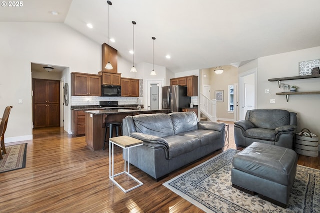 2085 Equestrian Loop S, Salem, OR 97302 - living area featuring dark wood-style flooring, stairs, high vaulted ceiling, and recessed lighting