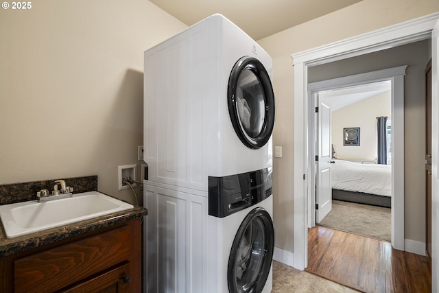 2085 Equestrian Loop S, Salem, OR 97302 - laundry room featuring estacked washer and dryer and wood finished floors