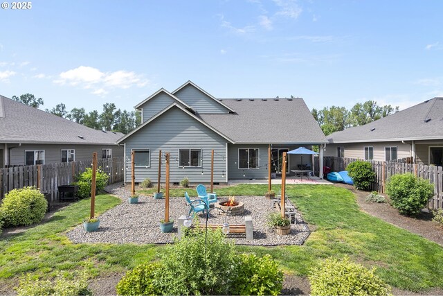 2085 Equestrian Loop S, Salem, OR 97302 - back of property with an outdoor fire pit, a patio, a fenced backyard, and a shingled roof