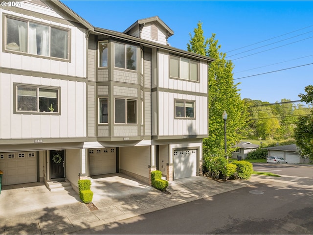 10450 SW Akilean Ter Unit 45, Portland, OR 97223 - view of property with a garage, board and batten siding, and driveway