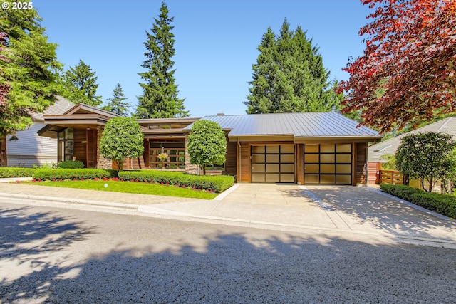17907 SW Cicero Ct, Beaverton, OR 97007 - view of front facade with an attached garage, driveway, and a metal roof