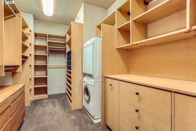 17907 SW Cicero Ct, Beaverton, OR 97007 - walk in closet featuring stacked washing machine and dryer and dark carpet